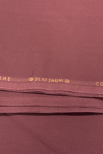 Close-up of maroon cotton fabric with Keen's Grace Platinum label.